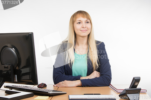 Image of Beautiful girl secretary waits for visitor