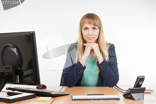 Image of Strict head sitting at a desk