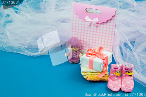 Image of The baby clothes with a  white gift box