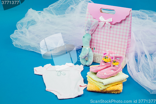 Image of The baby clothes with a  white gift box