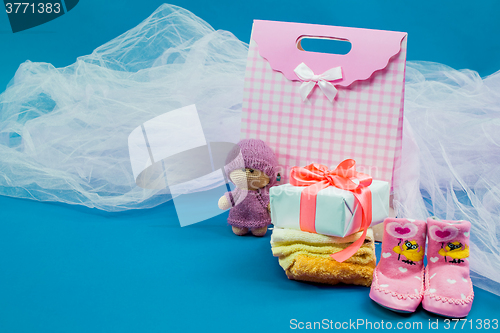 Image of The baby clothes with a  white gift box