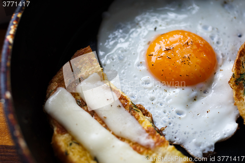 Image of fried egg and bread with cheese