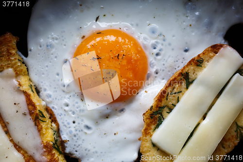 Image of fried egg and bread with cheese