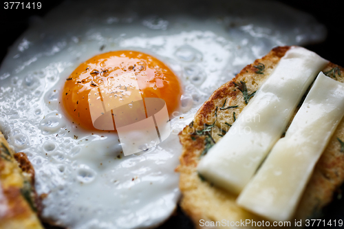 Image of fried egg and bread with cheese