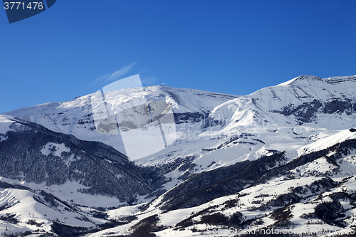 Image of Snowy sunlight mountains at sun day