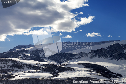 Image of Snowy sunlight mountains at sun evening