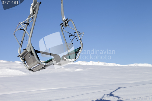 Image of Chair-lift in ski resort at sun day after snowfall
