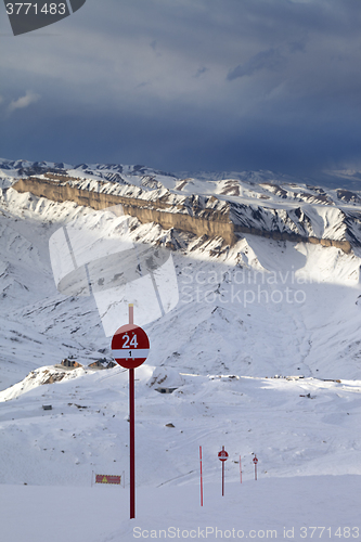 Image of Ski slope at evening and storm sky