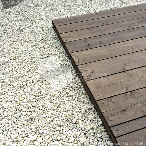 Image of Wooden deck and white decorative stones