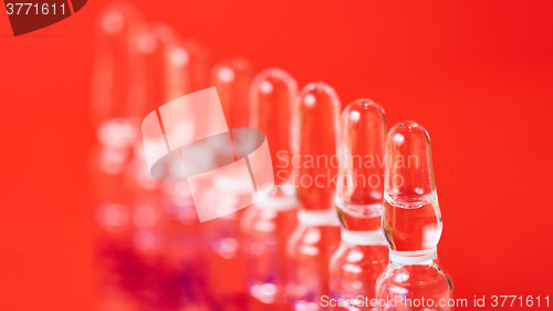 Image of Medical ampules on a red background, selective focus. 