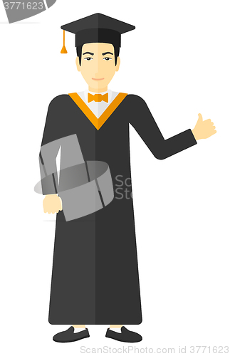 Image of Graduate showing thumb up sign.