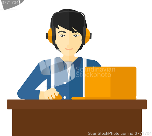 Image of Man working at laptop.