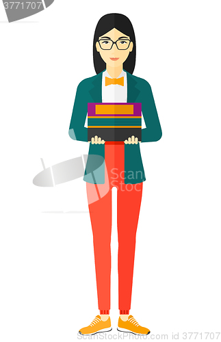 Image of Woman holding pile of books.