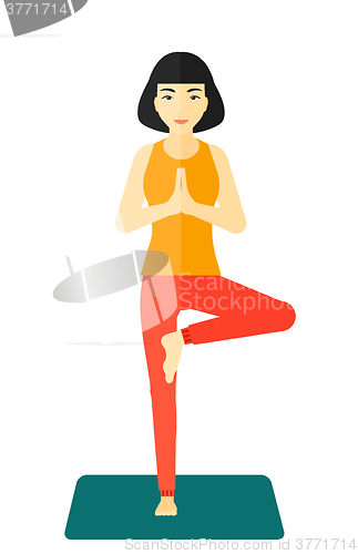 Image of Woman practicing yoga.