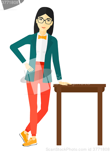 Image of Woman leaning on table.