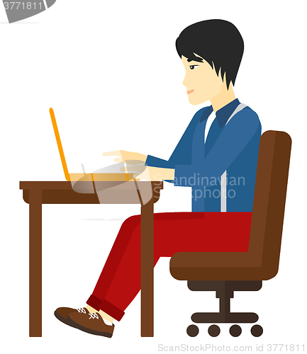 Image of Man working at laptop.