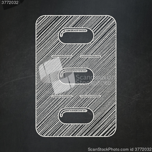 Image of Medicine concept: Pills Blister on chalkboard background