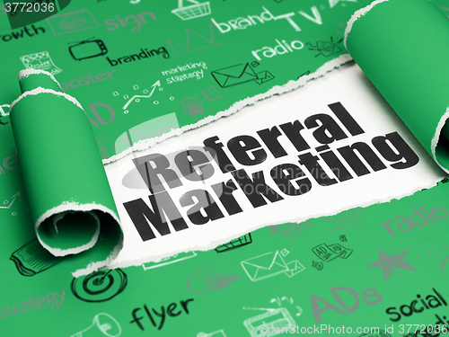 Image of Marketing concept: black text Referral Marketing under the piece of  torn paper