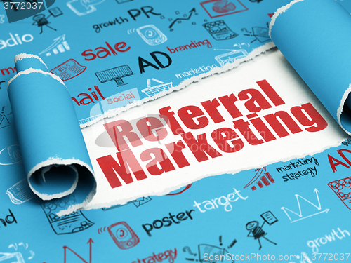 Image of Marketing concept: red text Referral Marketing under the piece of  torn paper