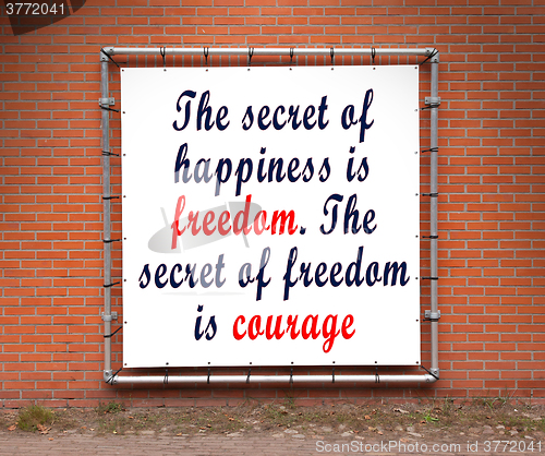 Image of Large banner with inspirational quote on a brick wall