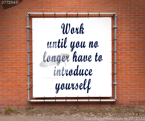 Image of Large banner with inspirational quote on a brick wall