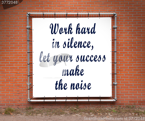 Image of Large banner with inspirational quote on a brick wall