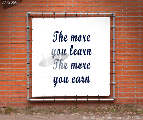 Image of Large banner with inspirational quote on a brick wall