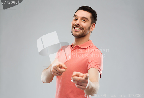 Image of man pointing finger to you over gray background