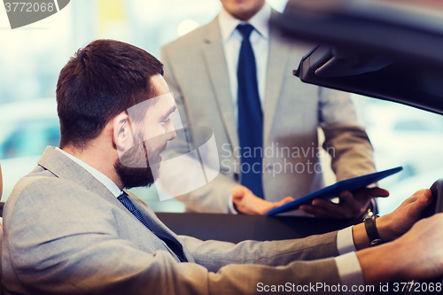 Image of happy man with car dealer in auto show or salon