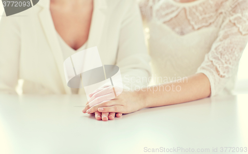 Image of close up of happy married lesbian couple hands