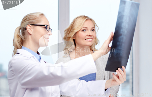 Image of woman patient and doctor with spine x-ray scan