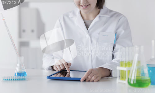 Image of close up of scientist with tablet pc in lab