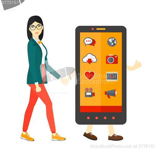 Image of Woman walking with smartphone.