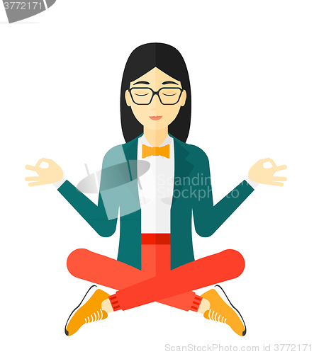 Image of Business woman meditating in lotus pose.