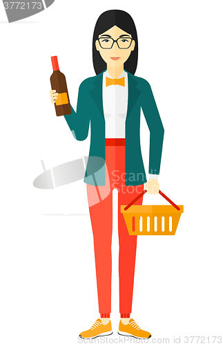 Image of Customer with shopping basket and bottle of wine.