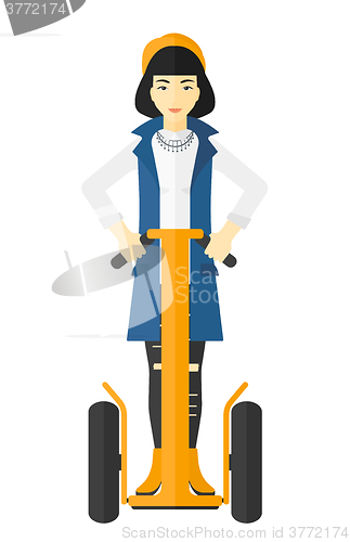 Image of Woman riding on electric scooter.