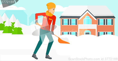 Image of Woman shoveling and removing snow.