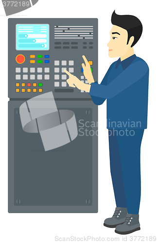 Image of Engineer standing near control panel.