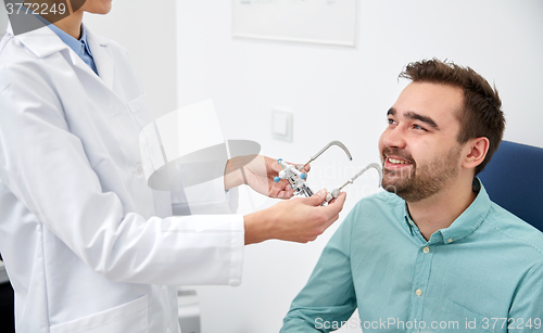 Image of optician with trial frame and patient at clinic