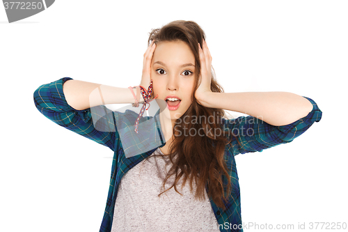 Image of happy pretty teenage girl holding to head