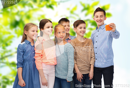 Image of happy children talking selfie by smartphone