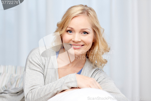 Image of happy middle aged woman at home