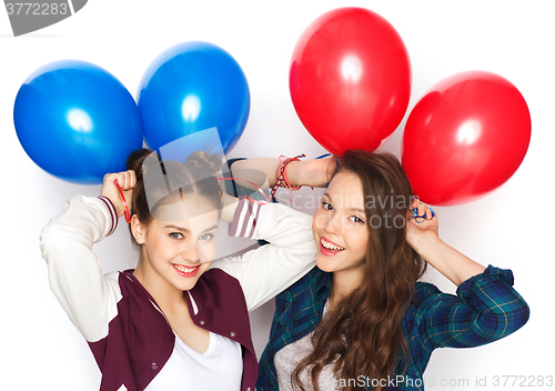 Image of happy teenage girls with helium balloons