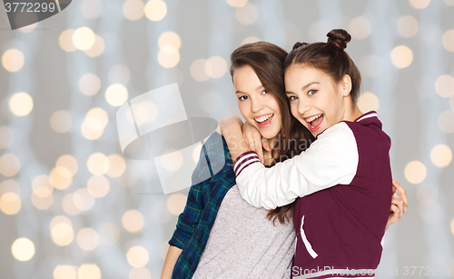 Image of happy smiling pretty teenage girls hugging