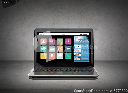 Image of laptop computer with application icons screen