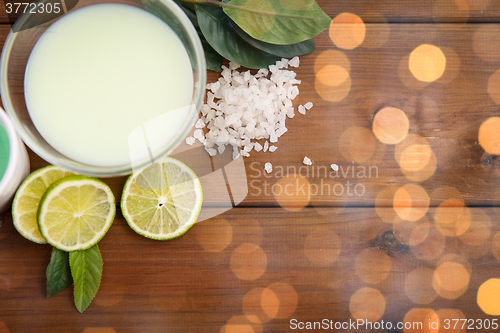 Image of close up of citrus body lotion in bowl on wood