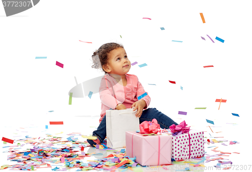 Image of happy little baby girl with birthday presents