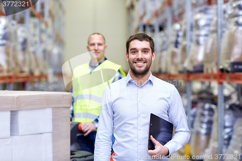 Image of businessman with clipboard  over warehouse loader