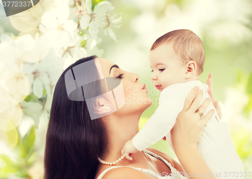 Image of happy laughing baby playing with mother