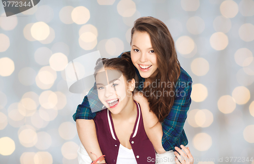 Image of happy smiling pretty teenage girls hugging